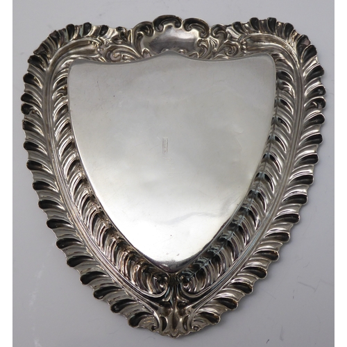 112 - Silverware comprising a heart-shaped trinket dish with raised repoussé-style foliate border and vaca... 