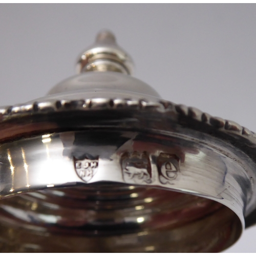 117 - A hallmarked silver hot water jug of baluster form and high arched scrolling ebonised handle, maker'... 