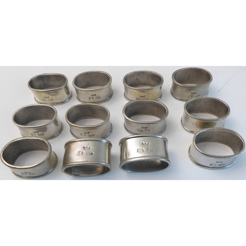 63 - A set of twelve modern pewter napkin rings - in the 19th century style, oval and with touch marks