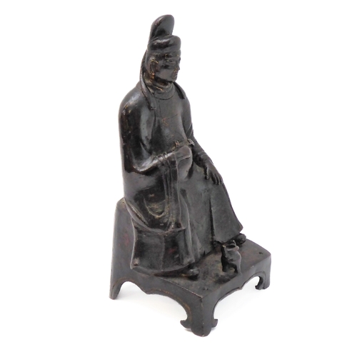 74 - A patinated Chinese bronze of a high ranking official with headdress and long flowing robe, seated b... 