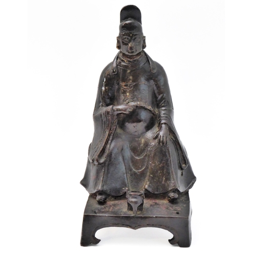 74 - A patinated Chinese bronze of a high ranking official with headdress and long flowing robe, seated b... 