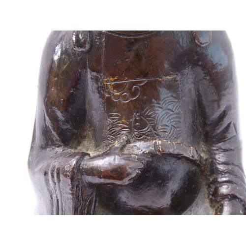 74 - A patinated Chinese bronze of a high ranking official with headdress and long flowing robe, seated b... 