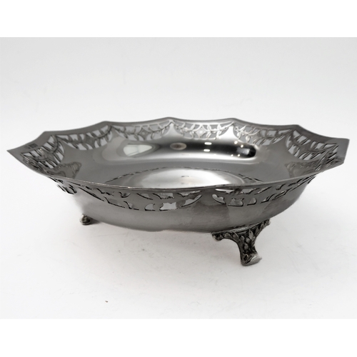 96 - A hallmarked silver bowl; pierced swag style border and raised on three foliate cast feet, maker's m... 