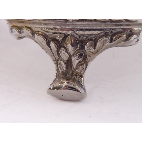 96 - A hallmarked silver bowl; pierced swag style border and raised on three foliate cast feet, maker's m... 