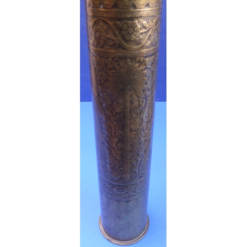 64 - An interesting selection of metalware: 

 - a large WWI Trench Art type brass shell case profusely e... 