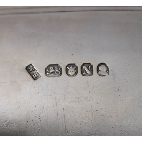 100 - A hallmarked silver salver of rectangular shape; raised gadrooned border and on four shaped feet, ma... 
