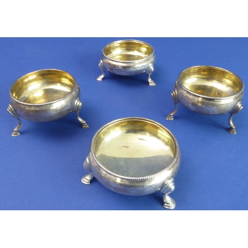 102 - A pair of 18th century hallmarked silver circular salts with gilded interior bowls and each on three... 