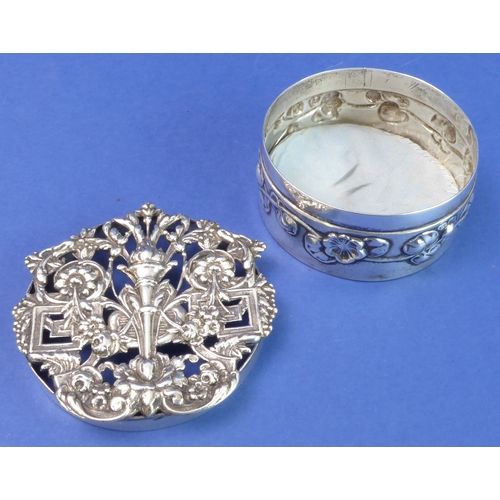 91 - A circular hallmarked silver trinket/silver jewellery box; the elaborately decorated and pierced cov... 