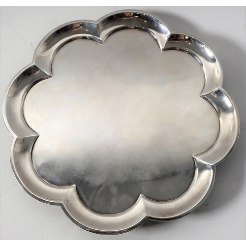 99 - A heavy hallmarked silver salver of flowerhead shape and raised on four bun-style feet' maker's mark... 