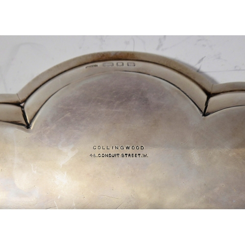 99 - A heavy hallmarked silver salver of flowerhead shape and raised on four bun-style feet' maker's mark... 