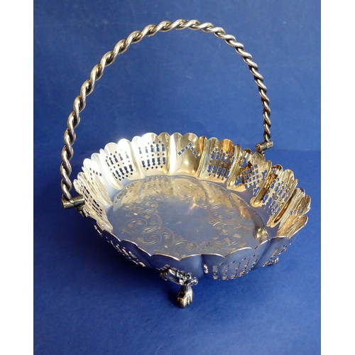 120 - A heavy hallmarked silver cake basket  rope-twist-style swing-handle above a castellated-style pier... 