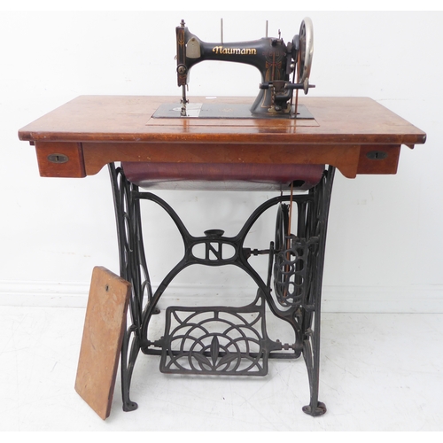 A Naumann treadle sewing machine with iron base; the machine ...