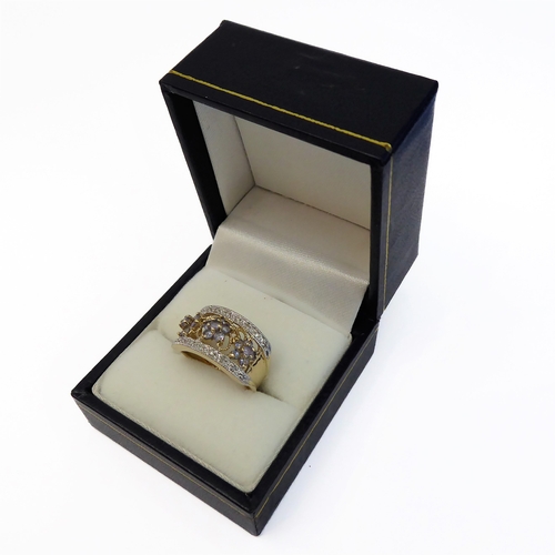 101 - A 9-carat gold dress ring set with small tanzanites and diamonds (boxed), ring size K/L