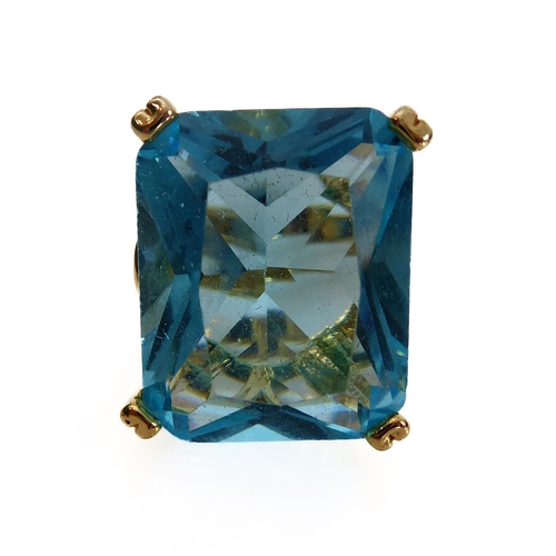 106 - A showy silver-gilt dress ring mounted with a large hand-cut vertically aligned rectangular aquamari... 