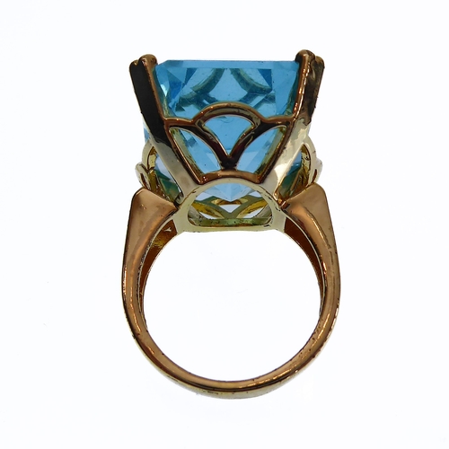 106 - A showy silver-gilt dress ring mounted with a large hand-cut vertically aligned rectangular aquamari... 