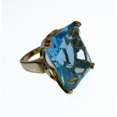 106 - A showy silver-gilt dress ring mounted with a large hand-cut vertically aligned rectangular aquamari... 