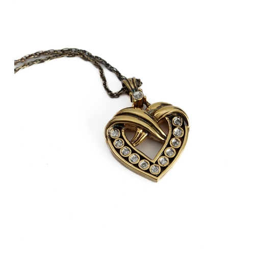 110 - A lady's heavy silver gilt heart-shaped crossover style pendant mounted with twelve diamonds (the re... 