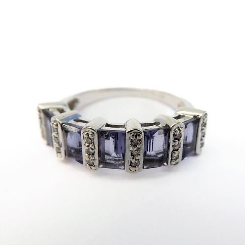 111 - A 9-carat white gold ring set with five baguette tanzanite stones and diamonds (boxed), ring size M