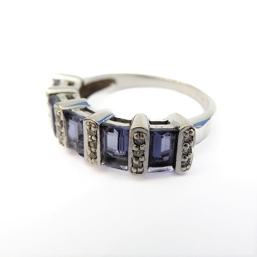 111 - A 9-carat white gold ring set with five baguette tanzanite stones and diamonds (boxed), ring size M