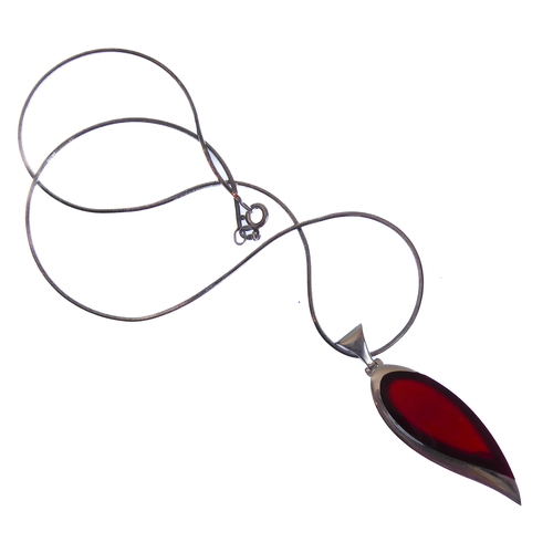 117 - An unusual silver mounted and red hardstone inverted teardrop-shaped pendant upon a silver chain, in... 