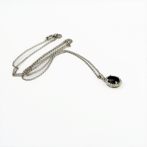 125 - A 14-carat white gold, sapphire and diamond pendant and chain