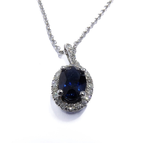 125 - A 14-carat white gold, sapphire and diamond pendant and chain