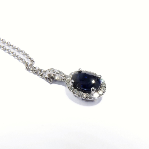 125 - A 14-carat white gold, sapphire and diamond pendant and chain