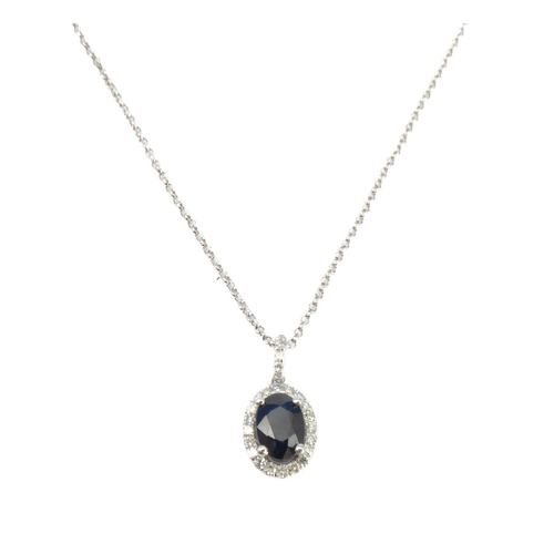 125 - A 14-carat white gold, sapphire and diamond pendant and chain