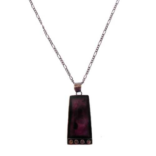 130 - An unusual silver pendant of tapering rectangular form and mounted with a dark amethyst-style polish... 