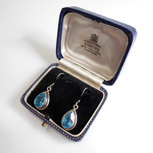 133 - A pair of lady's boxed teardrop-shaped silver earrings: each mounted with a hand-cut aquamarine-styl... 