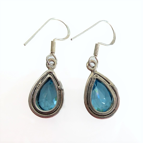 133 - A pair of lady's boxed teardrop-shaped silver earrings: each mounted with a hand-cut aquamarine-styl... 