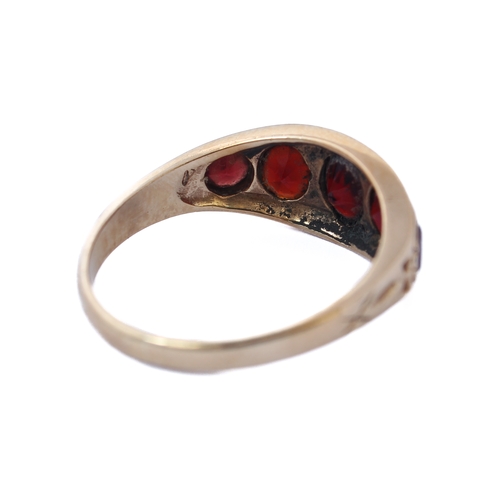 143 - A 9-carat gold gipsy-style ring set with five graduated garnets, ring size R/S