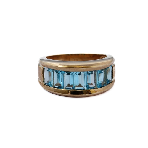 147 - A heavy 9-carat gold band ring set with blue topaz, ring size J/K