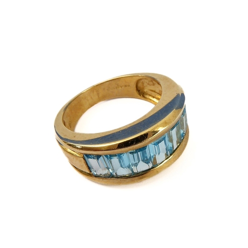 147 - A heavy 9-carat gold band ring set with blue topaz, ring size J/K