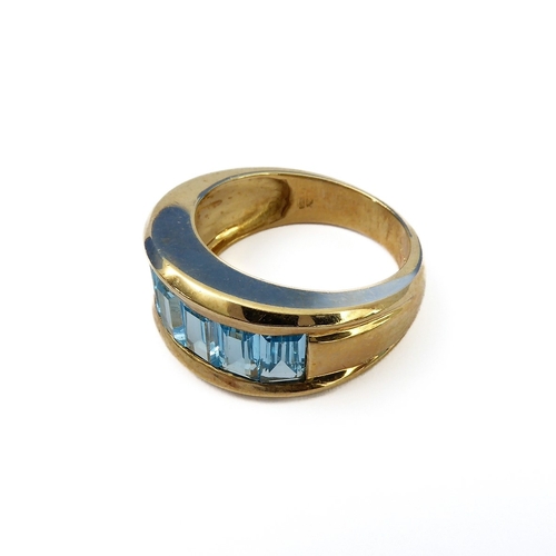 147 - A heavy 9-carat gold band ring set with blue topaz, ring size J/K