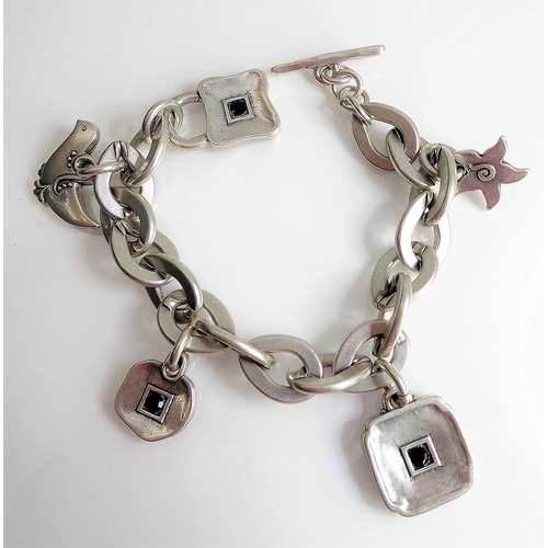 148 - An unusual bracelet set with various charms and signed 'Danon'