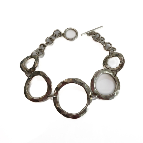 150 - A silver bracelet modelled as angular concentric circles