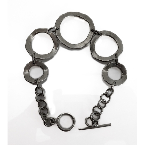 150 - A silver bracelet modelled as angular concentric circles