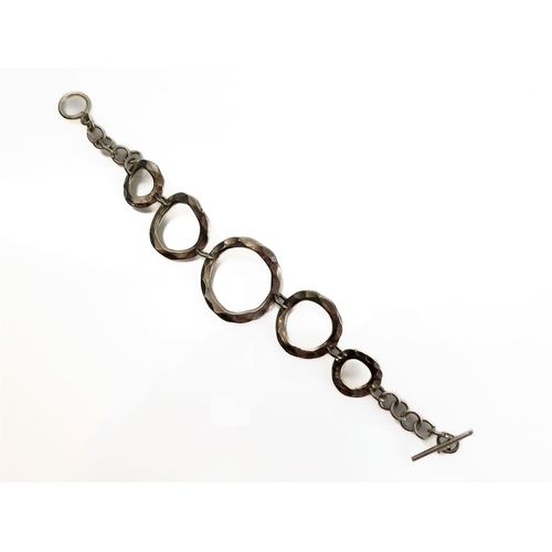 150 - A silver bracelet modelled as angular concentric circles