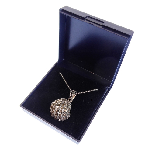 155 - A scallop-shell-shaped Art-Deco-style silver marquisate-mounted pendant on a silver chain (boxed)