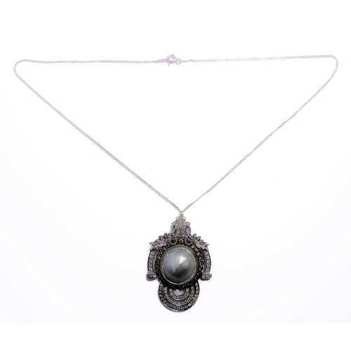 158 - An 18-carat white gold pendant centred with a large mabé pearl surrounded by champagne diamonds and ... 