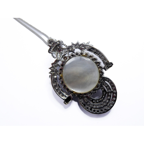 158 - An 18-carat white gold pendant centred with a large mabé pearl surrounded by champagne diamonds and ... 