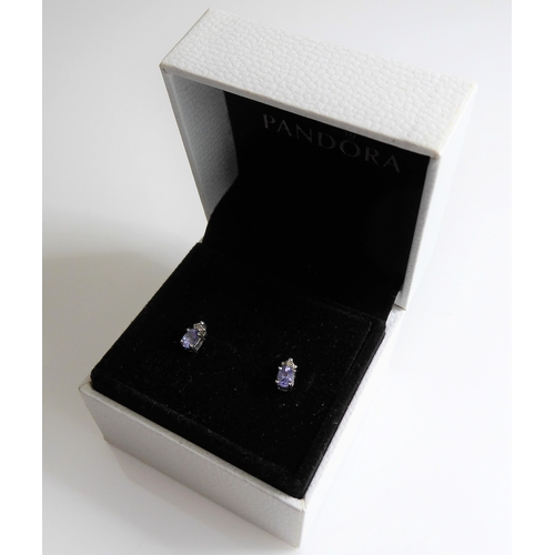 159 - A pair of silver stud earrings mounted with tanzanite stones and (possibly diamond) chips