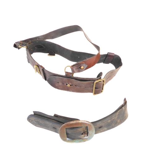 172 - An early 20th century Sam Browne belt, a heavy brass bridle buckle and two leather straps