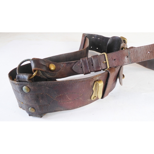 172 - An early 20th century Sam Browne belt, a heavy brass bridle buckle and two leather straps