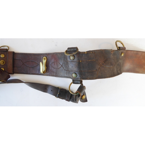 172 - An early 20th century Sam Browne belt, a heavy brass bridle buckle and two leather straps