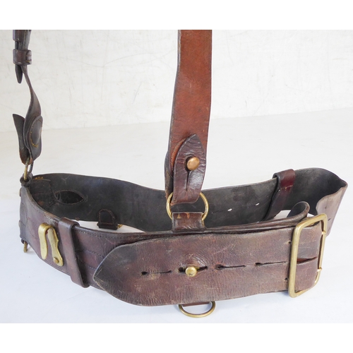 172 - An early 20th century Sam Browne belt, a heavy brass bridle buckle and two leather straps