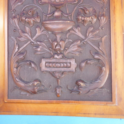 200 - A pair of early 20th century satin walnut panels: each intricately carved with scrolling foliage and... 