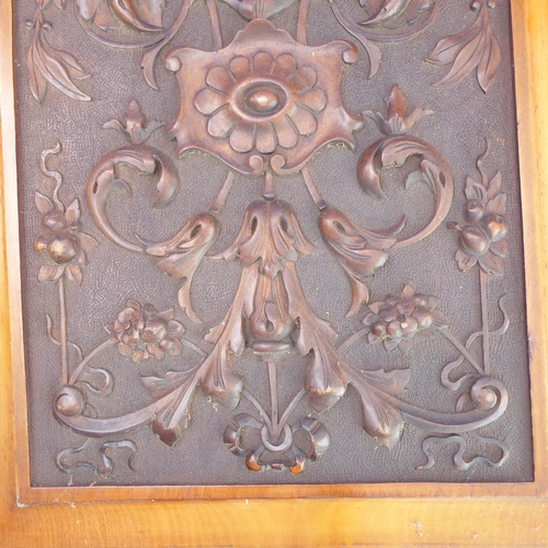 200 - A pair of early 20th century satin walnut panels: each intricately carved with scrolling foliage and... 