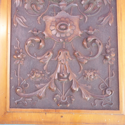 200 - A pair of early 20th century satin walnut panels: each intricately carved with scrolling foliage and... 